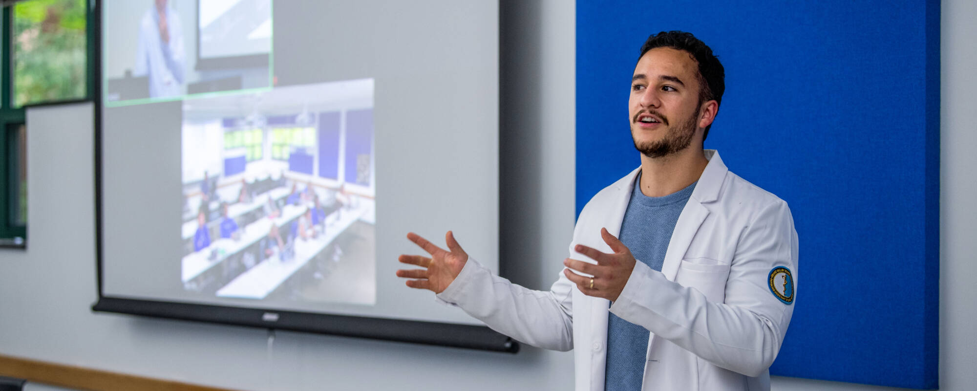 Physician assistant studies grad student Elias Sanchez shows off a Zoom room in NMC's Beckett Building, Front Street Campus.